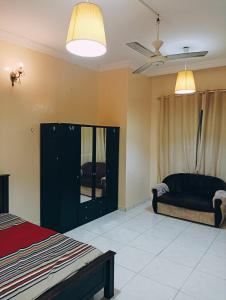 a bedroom with a bed and a black cabinet at Fully Furnished Room Here With Good Vibes in Ajman 