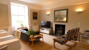 a living room with a couch and a tv at Kirkland House B&B in Tarbert