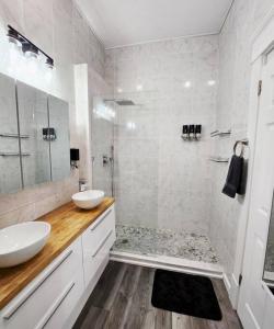 a white bathroom with a sink and a shower at Buckeye Sports, Mins to CP & SF, King/WD/Pet OK in Sandusky