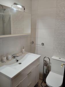 a white bathroom with a sink and a toilet at Apartamentos nova de abaixo 3 in Pontevedra