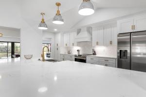Cucina o angolo cottura di Tropical Tranquility! Luxury pool home with lakefront view just minutes from the beach!