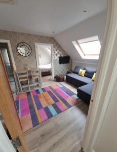 a living room with a couch and a rug at Modern loft with country views in Conlig