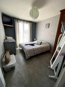 a bedroom with a bed and a window at Roxy House in Le Château-dʼOléron