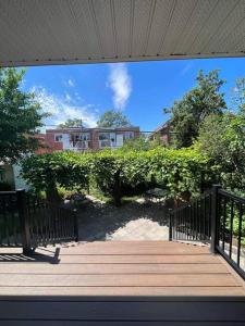 a wooden walkway with a building in the background at Family-Friendly 3BR Home with Backyard in Montréal