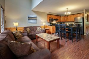 a living room with a couch and a table at Marblewood Village Resort in Steady Brook