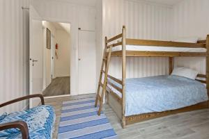 a bedroom with two bunk beds and a couch at Comfy 4-bedroom barnhouse Ideal for Long Stays in Åkersberga