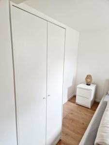 a bedroom with white wardrobes at Ferienwohnung Wehra in Wehr