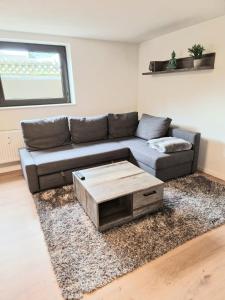 a living room with a couch and a coffee table at Ferienwohnung Wehra in Wehr
