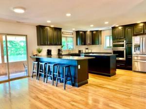 a kitchen with a blue island with bar stools at Mountain Top Oasis in Sevierville