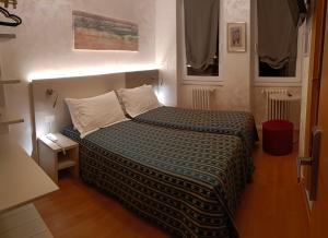 Ένα ή περισσότερα κρεβάτια σε δωμάτιο στο Hotel Angelini