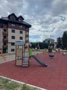 a playground with a slide and a play structure at Carpe Diem in Zlatibor