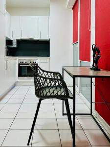 a kitchen with a table and a chair in it at ParkSide by BestChoice - Self Check-in with Parking Option in Graz