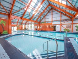 a large swimming pool in a large building at BelLa VistA - Holiday Home On The Beach in Clacton-on-Sea