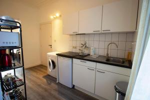 a kitchen with a sink and a washing machine at Handy Studio near Nato in Brussels