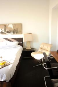a hotel room with a bed and a desk and a chair at Handy Studio near Nato in Brussels
