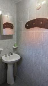 a bathroom with a white sink and a mirror at Lo de Lili Departamentos Mina Clavero in Mina Clavero