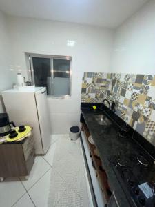 a kitchen with a sink and a refrigerator at Francisco's House in Angra dos Reis