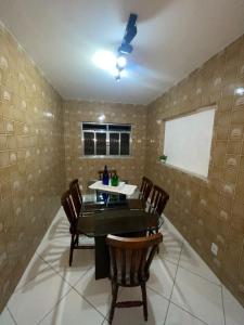 a dining room with a table and chairs at Francisco's House in Angra dos Reis