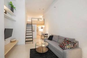 a living room with a couch and a table at CASA ALTA LOFT in Málaga