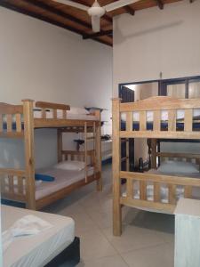 a room with three bunk beds in a room at Casa Yemaya in Necoclí