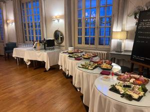 a row of tables with plates of food on them at Le Cheval Blanc in Jargeau