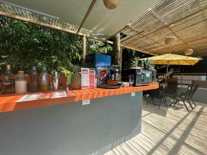 an outdoor bar with a table and chairs and an umbrella at Manuel Antonio Inn Paradise in Quepos