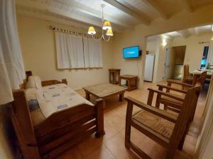 a living room with a table and chairs and a tv at Casa equipada para 8 personas a tres cuadras del mar - Colibrí 1 in Mar Azul