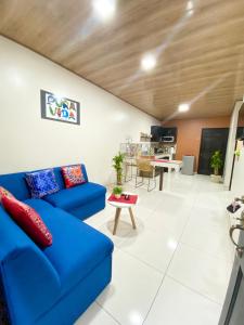 a living room with a blue couch and a table at Apartamentos H Gonzalez. Wifi A/C free parking in San Rafael