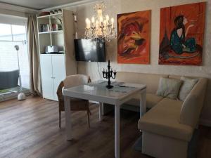 een woonkamer met een tafel en een bank bij Holiday apartment in Southern Alps in Haffkrug