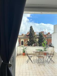 a view of a patio with a table and chairs at Regina Margherita Home in Rome