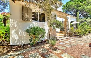 a white house with a window and a patio at La Maison De Nelly in Paradou
