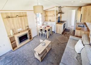 a living room with a couch and a table at Towervans Caravan Park in Mablethorpe