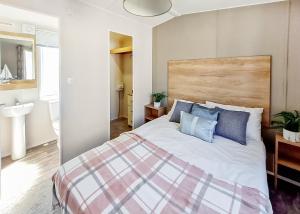 una camera da letto con un grande letto con cuscini blu di Towervans Caravan Park a Mablethorpe