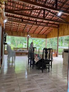 a pavilion with chairs and a zebra on a tile floor at casa do lago, paz e sossego. in Guaramirim