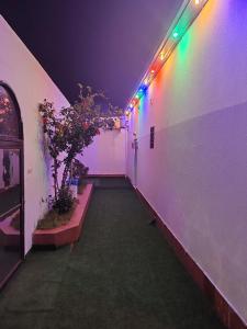 a hallway with colorful lights on the side of a building at منتجع الريحانه فلة رقم ٢ in Al Wahţ