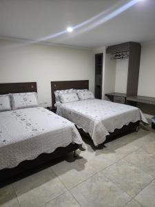 Postel nebo postele na pokoji v ubytování HOTEL CASA MARED Corferias-Embajada Americana