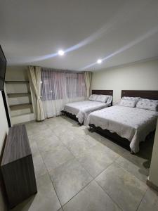 Postel nebo postele na pokoji v ubytování HOTEL CASA MARED Corferias-Embajada Americana