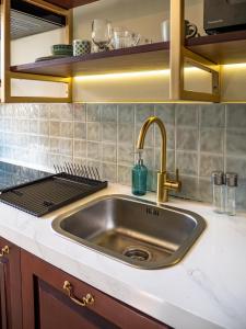 a kitchen with a sink and a stove at Tarate Loft Studio Ubud in Ubud
