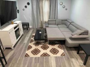 a living room with a couch and a tv at The Comfy Suite - 1BR with Free Parking in Paterson