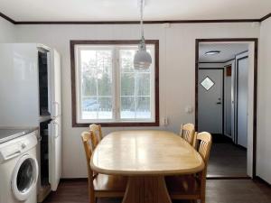 a kitchen with a dining room table and a washing machine at 4 star holiday home in NORRTÄLJE-By Traum in Norrtälje