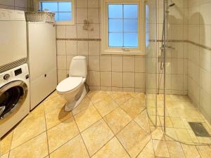 a bathroom with a toilet and a glass shower at 5 star holiday home in HÖÖR-By Traum in Höör +21 photos
