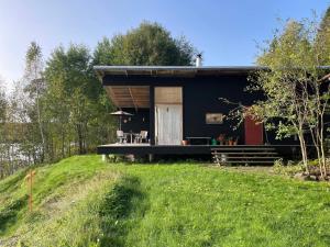 a small house on top of a grassy hill at 4 star holiday home in GRYTHYTTAN-By Traum in Grythyttan