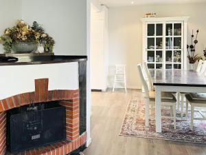 a living room with a fireplace and a dining room table at Holiday home GÖTEBORG V in Gothenburg