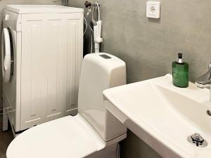 a bathroom with a white toilet and a sink at 4 star holiday home in Olofström-By Traum in Olofström