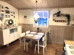 a kitchen with a table and chairs and a window at Holiday home Idre VII in Idre