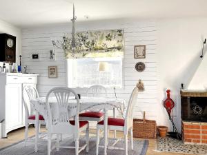 a dining room with a white table and chairs at Holiday home Linköping II in Linköping