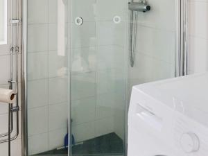 a glass shower in a bathroom with a sink at 6 person holiday home in MELLBYSTRAND-By Traum in Mellbystrand +22 photos
