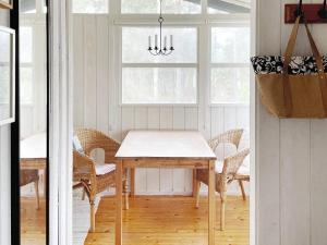 a dining room with a table and chairs at Holiday home GRISSLEHAMN XIV in Grisslehamn