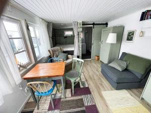 a small living room with a table and a couch at 4 star holiday home in Öckerö-By Traum in Öckerö