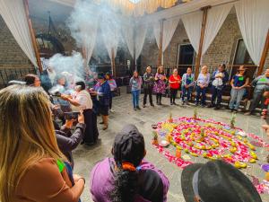 a group of people standing around a large cake at Golden Rest Ecuador in Latacunga